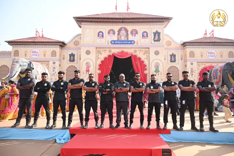 Twelve Golden Hawk Security guards standing in a line on a red carpet in front of a decorated festival gate