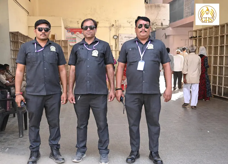 Three guards wearing sunglasses, ID badges and carrying radios